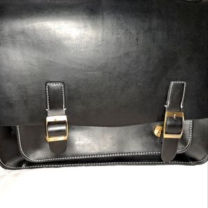 Leather like briefcase. Holds a 13 inch laptop.